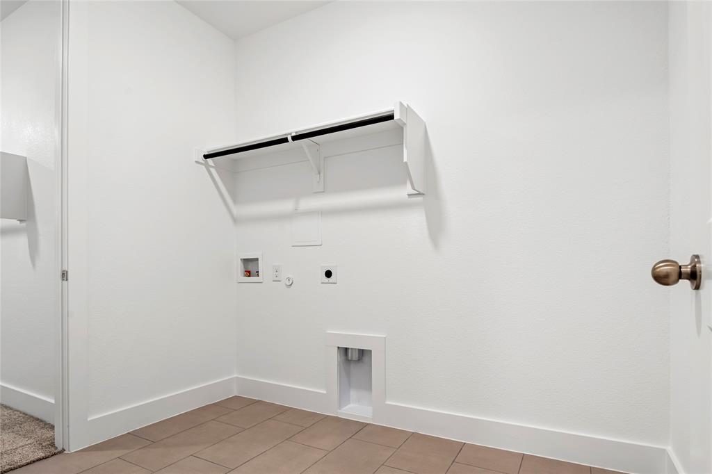 2900 Barbary Road McKinney, TX 75071 - Photo 27 of 36 Dedicated utility space featuring a built-in shelf and hanging rod, tile flooring, and white baseboards