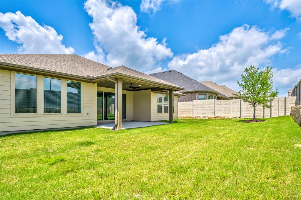 2900 Barbary Road McKinney, TX 75071 - Photo 35 of 36 Expansive green lawn with a covered patio featuring a ceiling fan