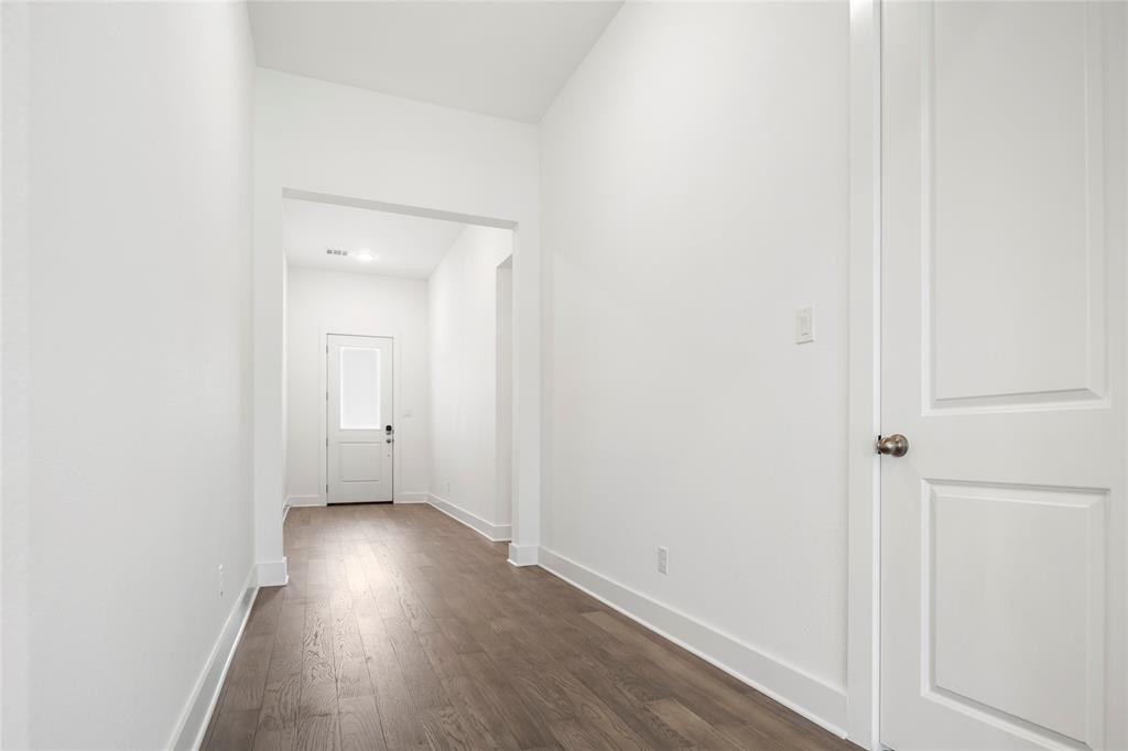 2900 Barbary Road McKinney, TX 75071 - Photo 4 of 36 Bright interior hallway featuring wood-finish flooring, white walls, and a recessed ceiling light