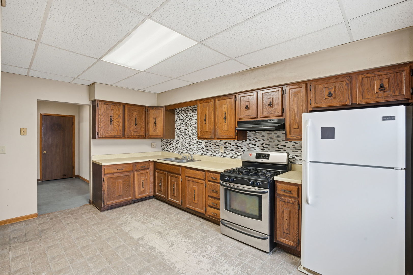 903 44th Street Rock Island, IL 61201 - Photo 9 of 28 a kitchen with granite countertop a sink stove and refrigerator