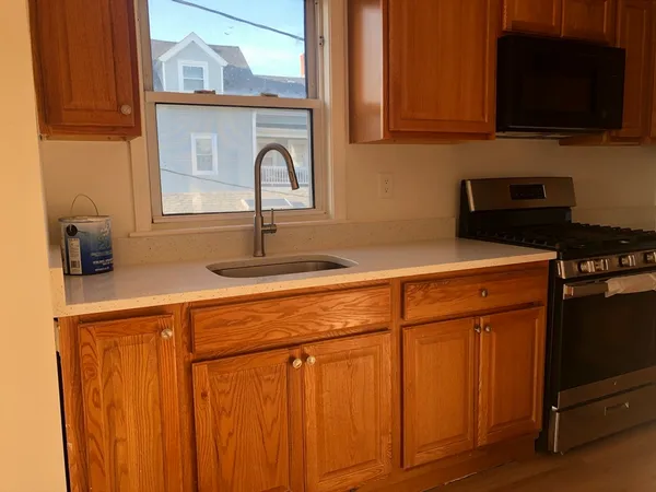a kitchen with stainless steel appliances a stove microwave and cabinets