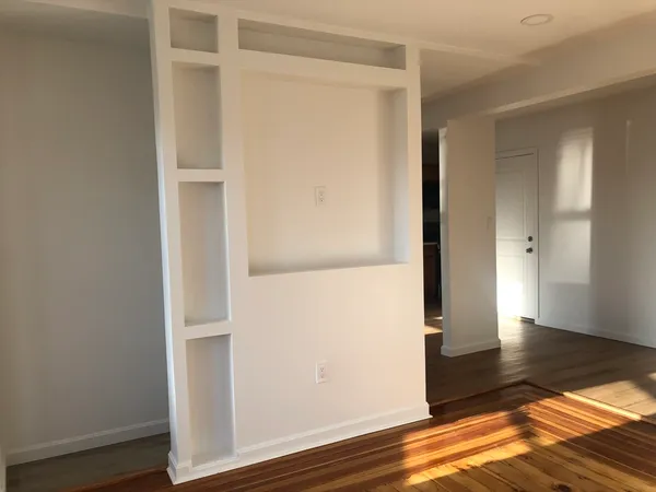 a view of room with wooden floor and window