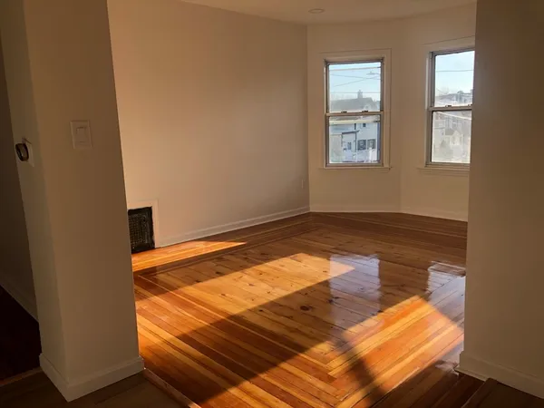 a view of a room with wooden floor