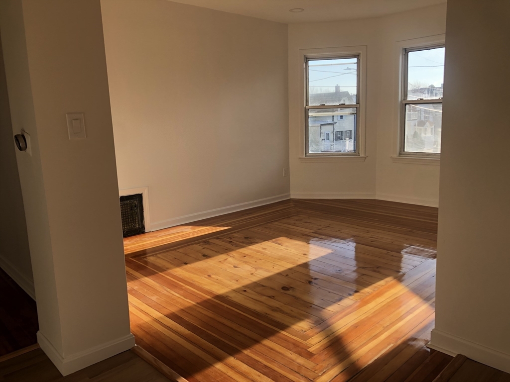 83-85 Neptune Street, Unit 2 Lynn, MA 01905 - Photo 5 of 8 a view of room with wooden floor and window