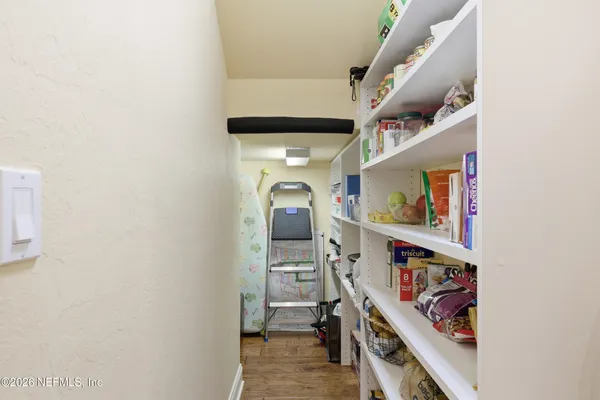 a view of walk in closet with clothes