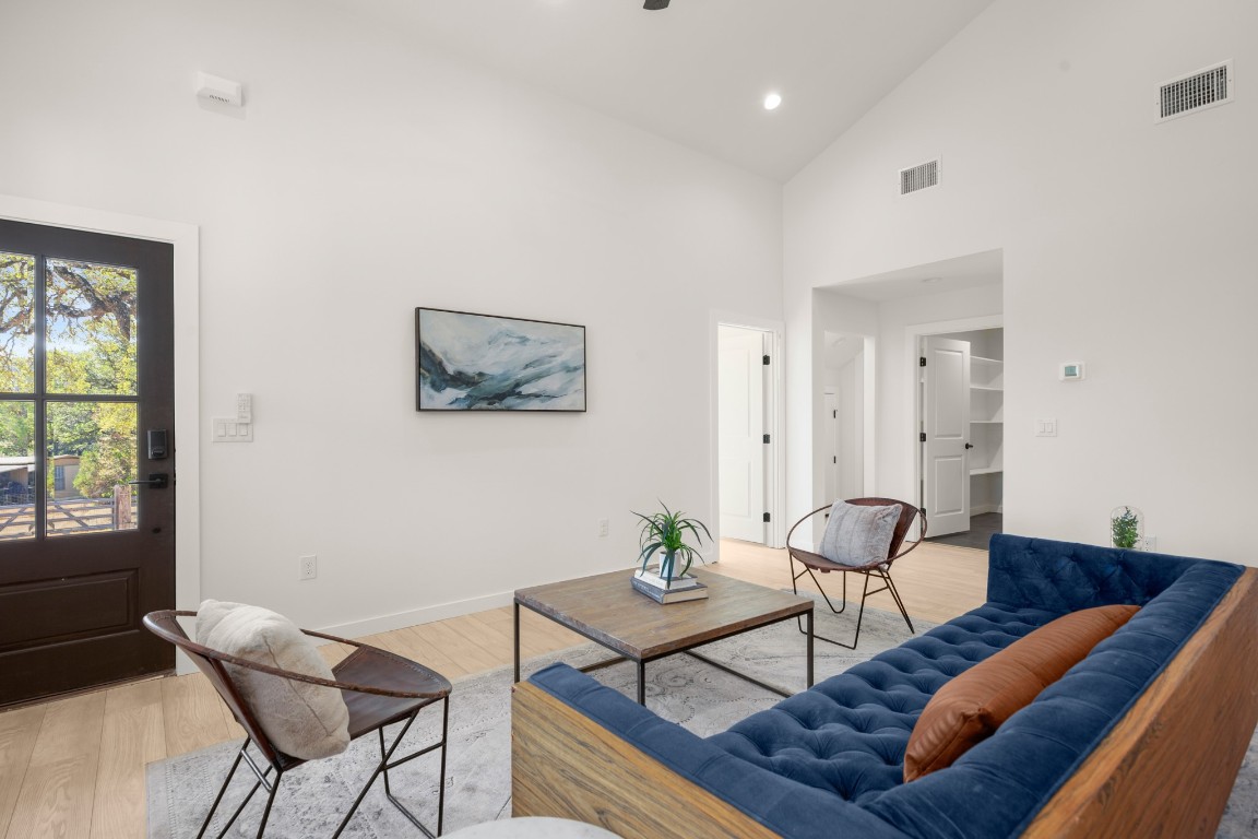 18208 Gregg Bluff Road Jonestown, TX 78645 - Photo 11 of 28 Living area featuring high vaulted ceiling, light wood-style floors, and recessed lighting