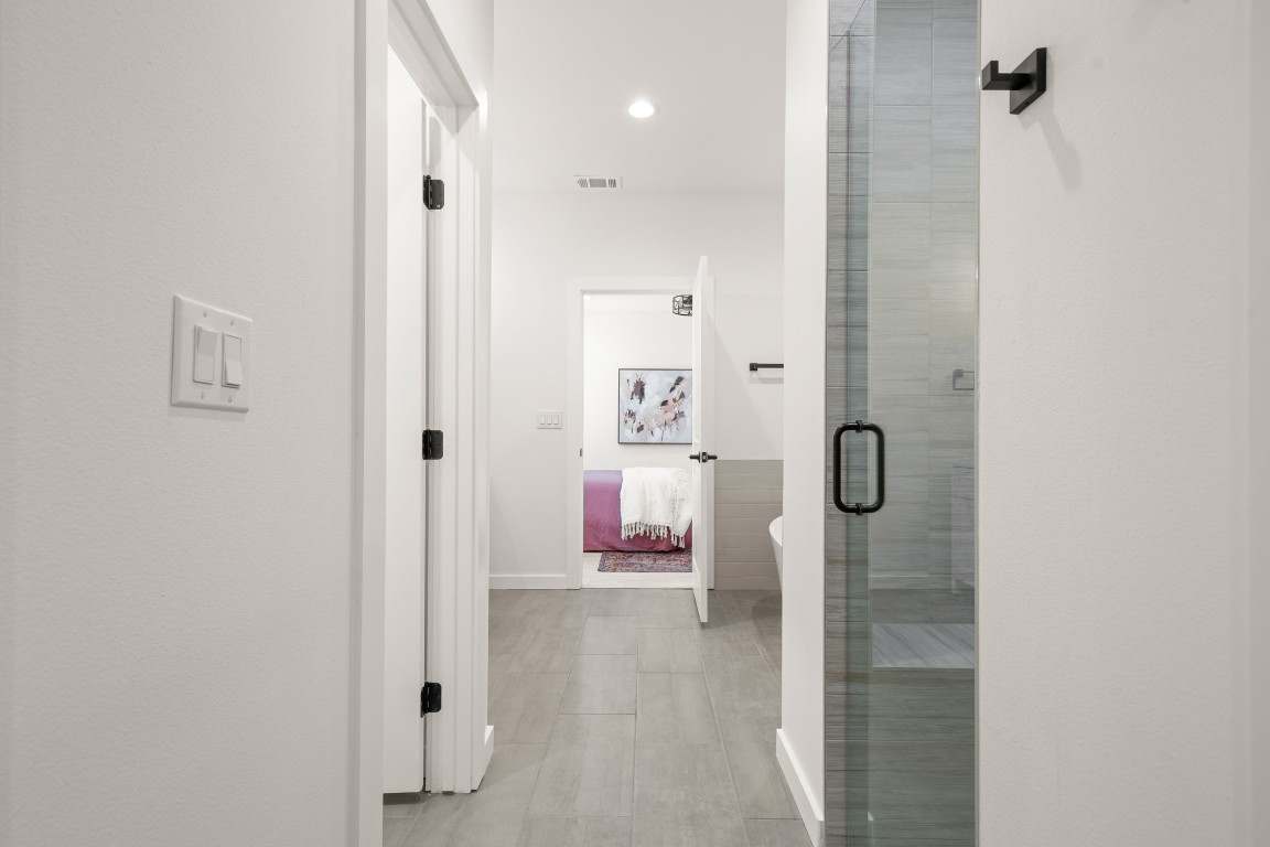 18208 Gregg Bluff Road Jonestown, TX 78645 - Photo 19 of 28 Hallway with recessed lighting and light tile patterned floors