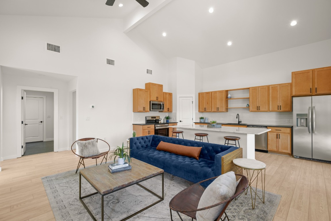 18208 Gregg Bluff Road Jonestown, TX 78645 - Photo 2 of 28 Living area with beamed ceiling, light wood-style floors, high vaulted ceiling, recessed lighting, and a ceiling fan
