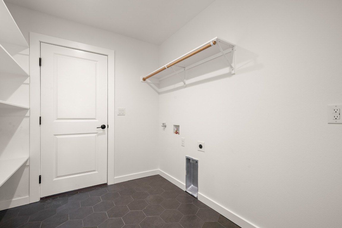 18208 Gregg Bluff Road Jonestown, TX 78645 - Photo 22 of 28 Laundry area with washer hookup, hookup for an electric dryer, gas dryer hookup, and dark tile patterned floors
