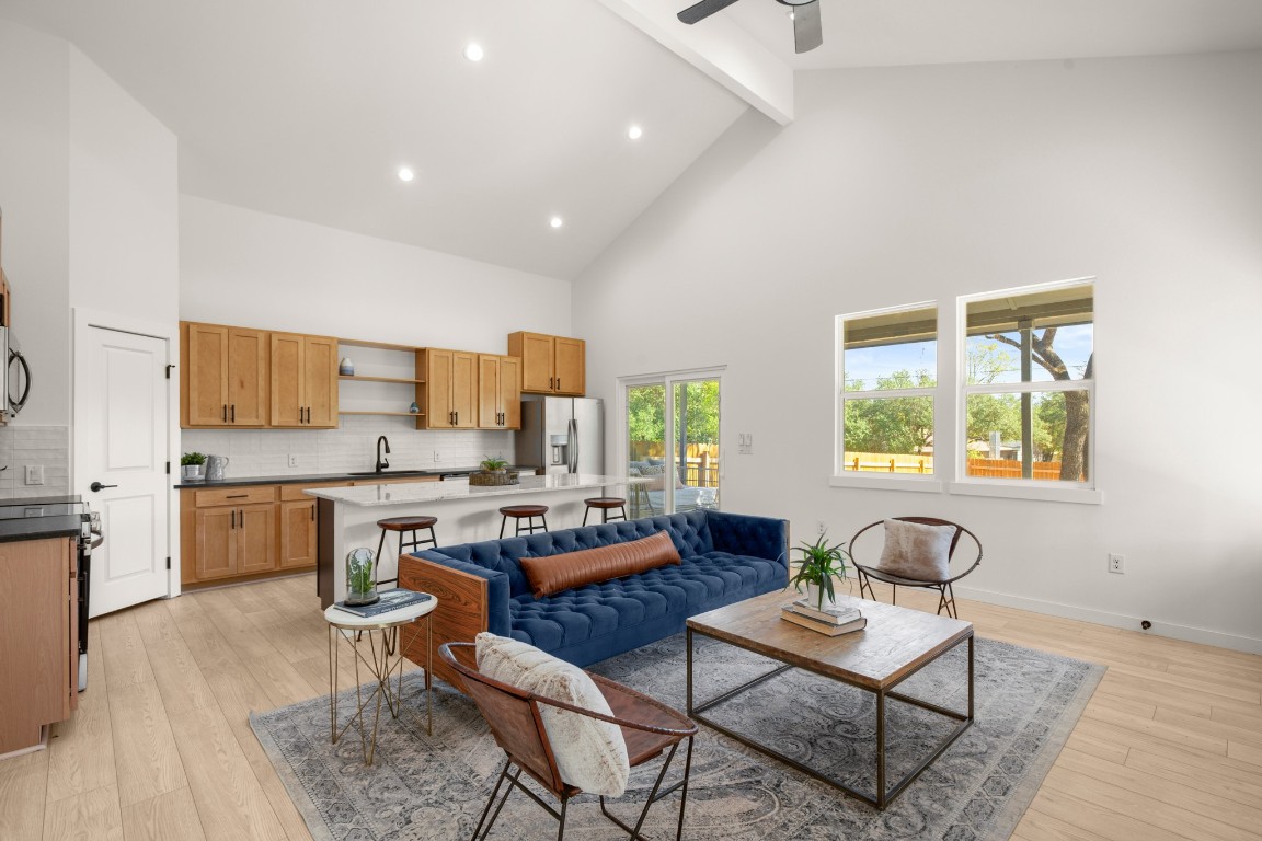 18208 Gregg Bluff Road Jonestown, TX 78645 - Photo 3 of 28 Living area featuring high vaulted ceiling, beam ceiling, light wood-type flooring, recessed lighting, and a ceiling fan