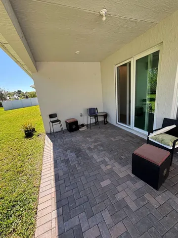 a lobby with furniture and floor to ceiling window