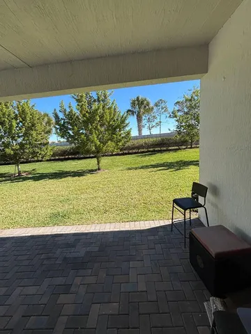 a view of a swimming pool and an outdoor seating