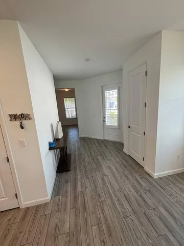 wooden floor in an empty room with a window