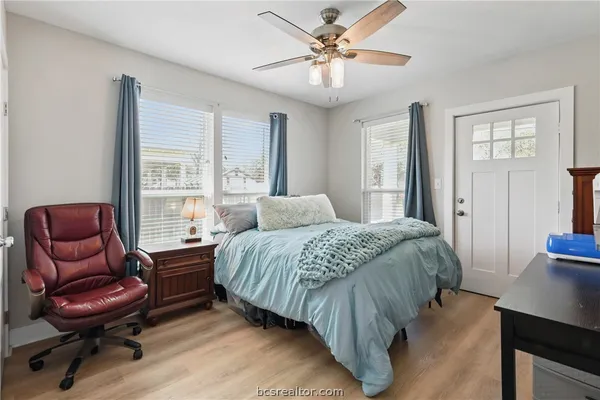 a bathroom with a granite countertop sink mirror and a bathtub