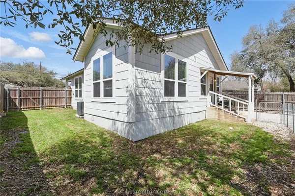 a view of a house with a yard covered in snow