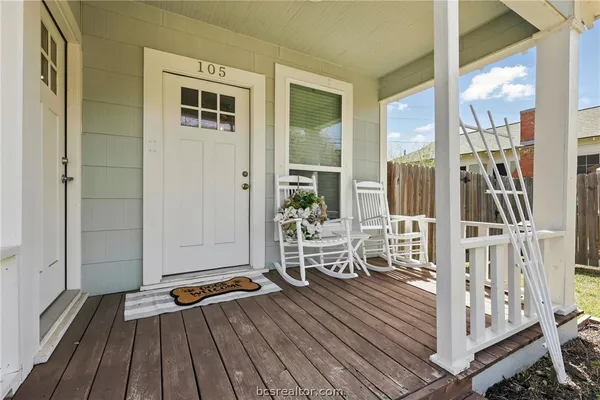 a view of a balcony with chairs and with wooden floor