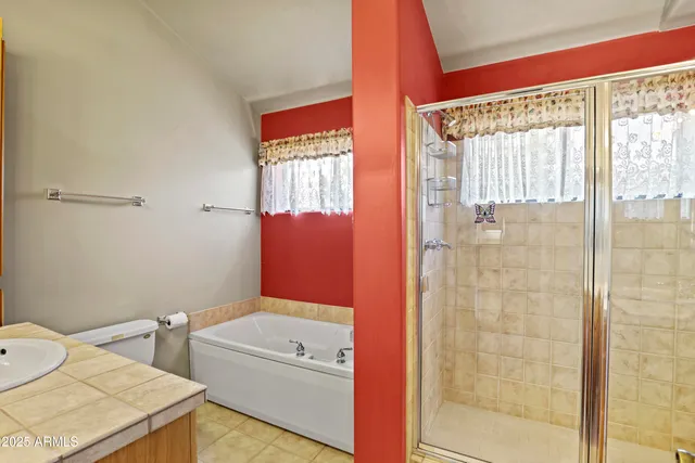 a spacious bathroom with a double vanity sink and a mirror