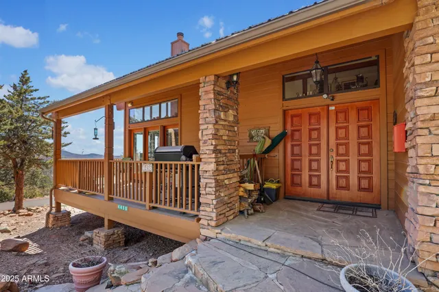 a backyard of a house with barbeque oven table and chairs