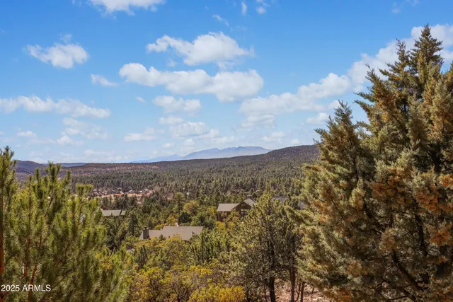 a balcony with wooden floor and city view