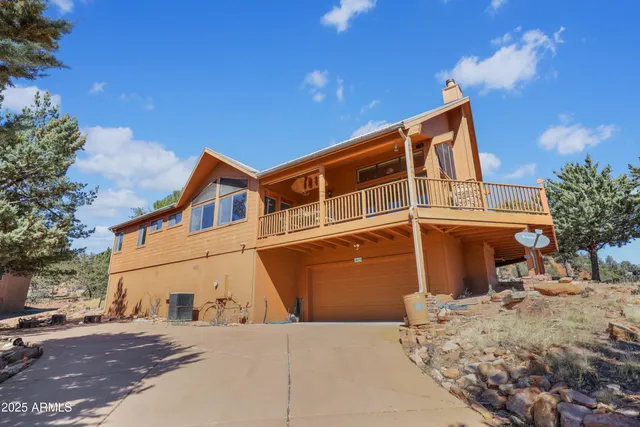 a backyard of a house with barbeque oven table and chairs