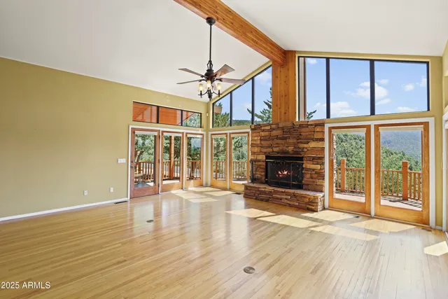 a view of an empty room with glass door and a window