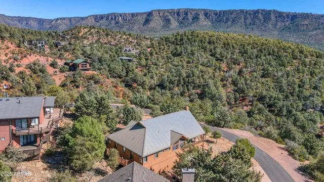 an aerial view of a house with a yard and balcony