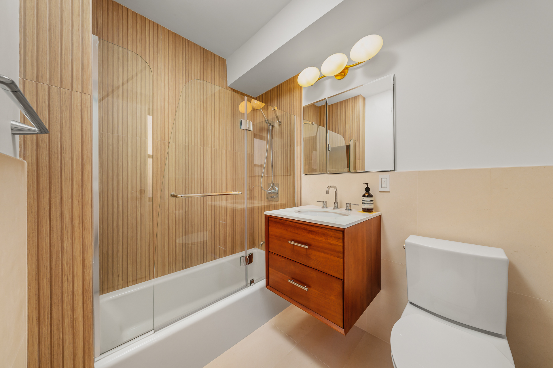 176 East 77th Street, Unit 5E Manhattan, NY 10075 - Photo 8 of 11 a bathroom with a sink a toilet and shower