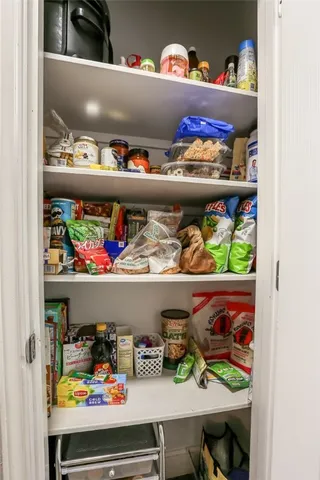 a cabinet with lots of different kinds of food