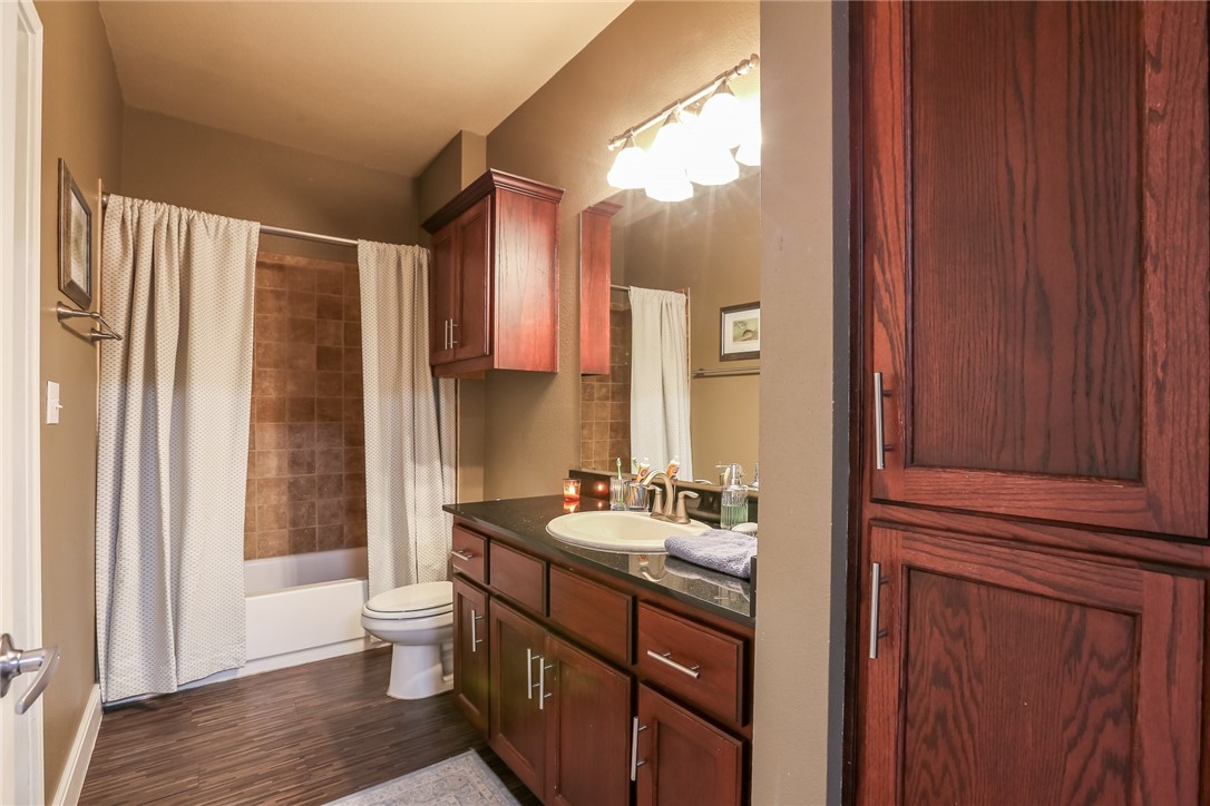 910 West 25th Street, Unit 204 Austin, TX 78705 - Photo 15 of 27 a bathroom with a double vanity sink a mirror and a bathtub