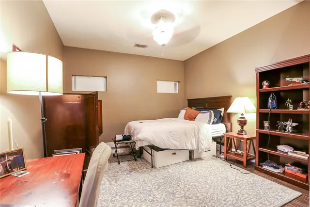 a bed room with a bed and a book shelf