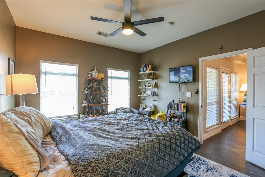 910 West 25th Street, Unit 204 Austin, TX 78705 - Photo 5 of 27 a bed room with a bed and a chandelier