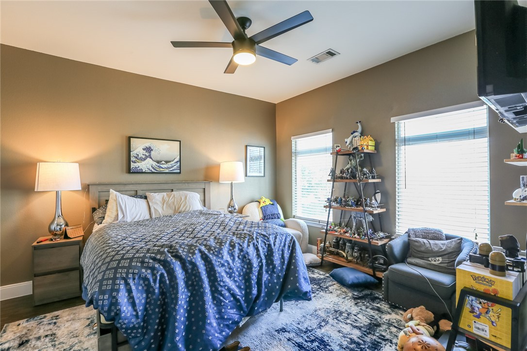 910 West 25th Street, Unit 204 Austin, TX 78705 - Photo 6 of 27 a bedroom with a bed a couch and a window