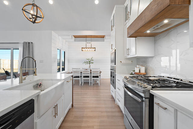 823 13th Street Wolfforth, TX 79382 - Photo 12 of 32 a kitchen with cabinets and chairs