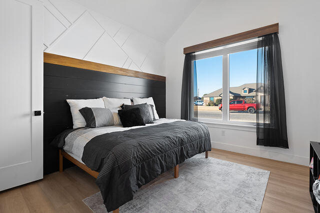 823 13th Street Wolfforth, TX 79382 - Photo 24 of 32 a spacious bedroom with a bed and a window