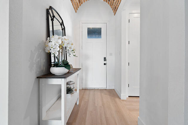 823 13th Street Wolfforth, TX 79382 - Photo 3 of 32 a view of a hallway with wooden floor and a chandelier