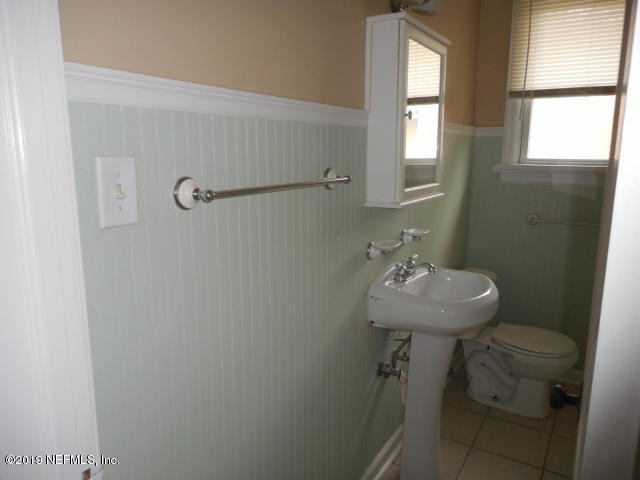 1774 Mayfair Road Jacksonville, FL 32207 - Photo 7 of 8 a bathroom with a sink a window and toilet