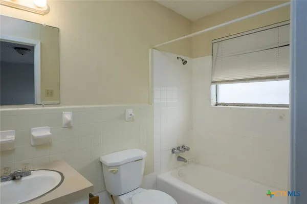 a bathroom with a toilet a sink and bathtub