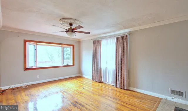 a view of a room with a chandelier fan and window
