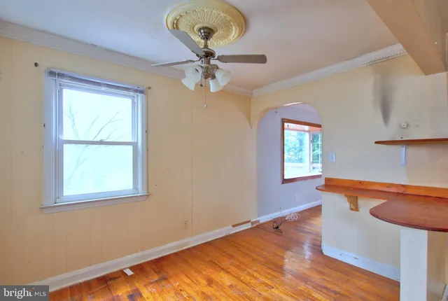 a view of room with window and wooden floor