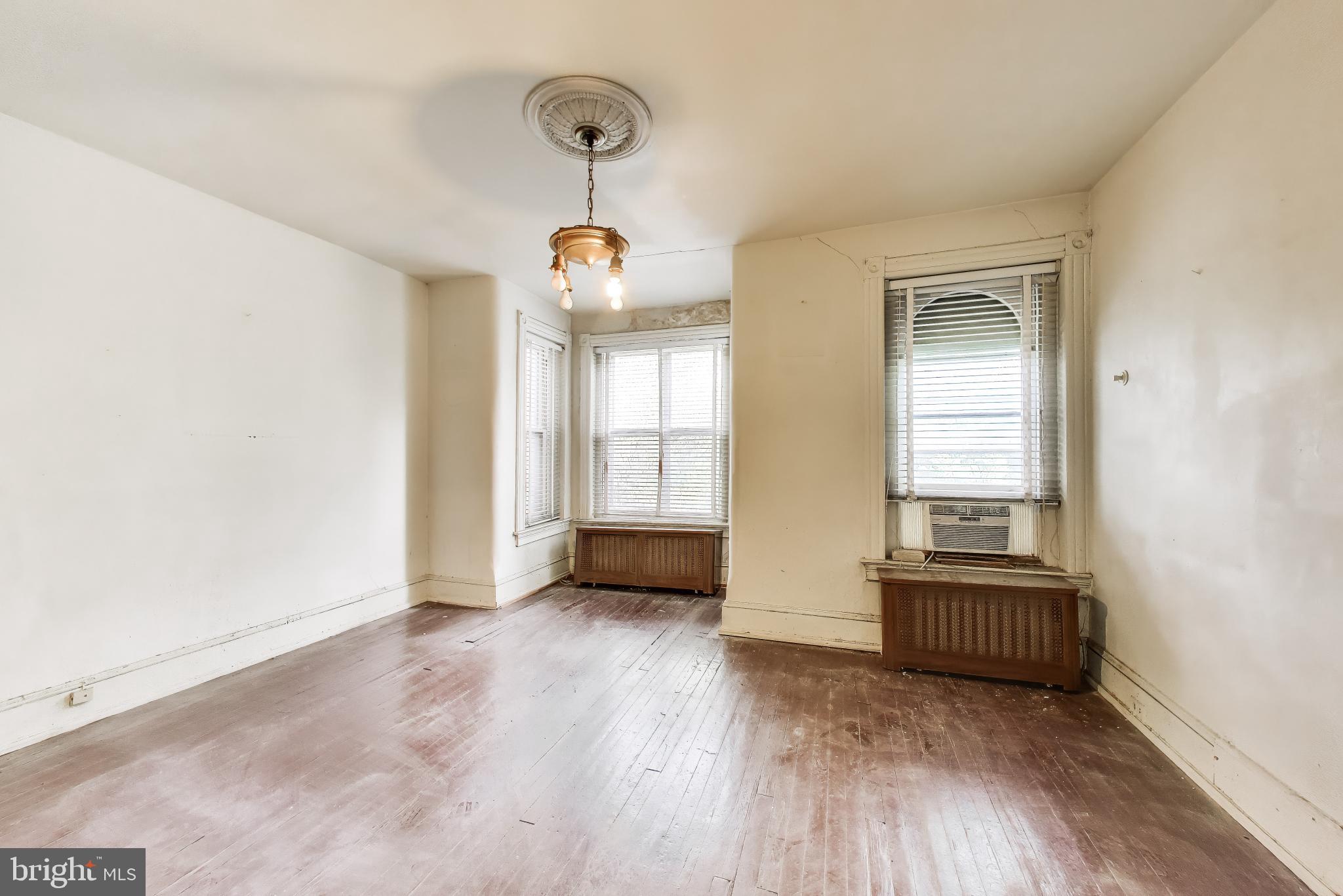 140 U Street Northwest Washington, DC 20001 - Photo 16 of 39 a view of an empty room with wooden floor and a window