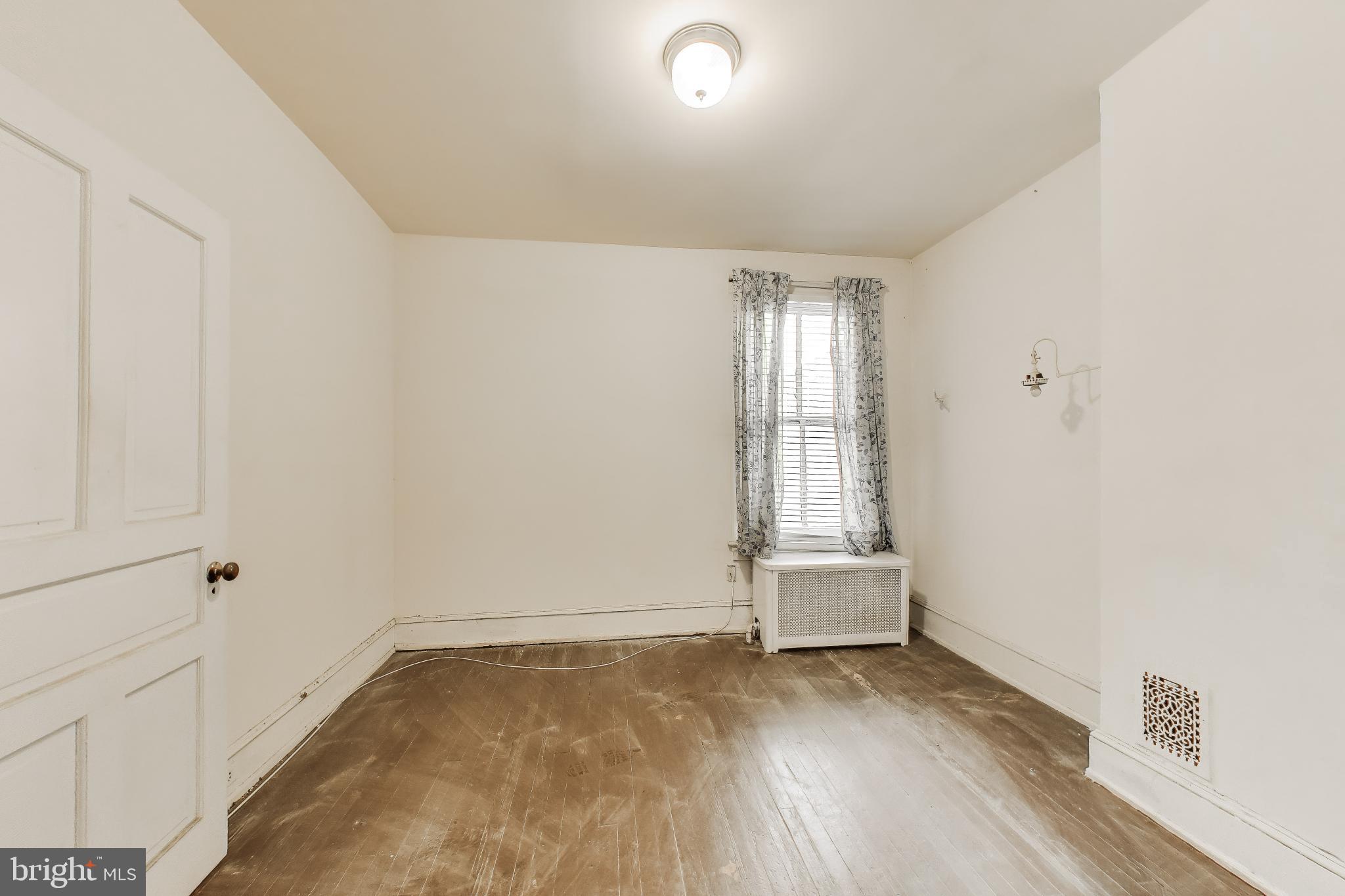 140 U Street Northwest Washington, DC 20001 - Photo 19 of 39 an empty room with wooden floor and windows