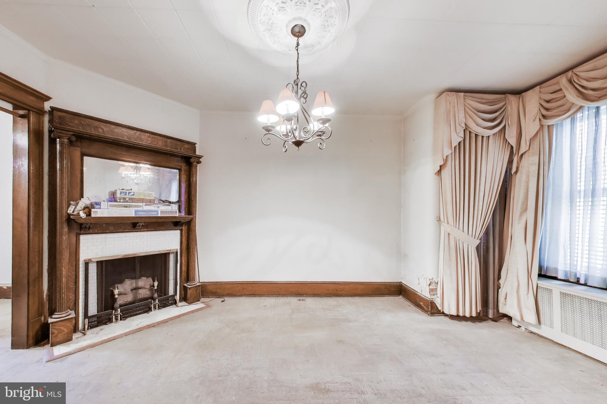 140 U Street Northwest Washington, DC 20001 - Photo 5 of 39 a view of a livingroom with a fireplace wooden floor and a chandelier
