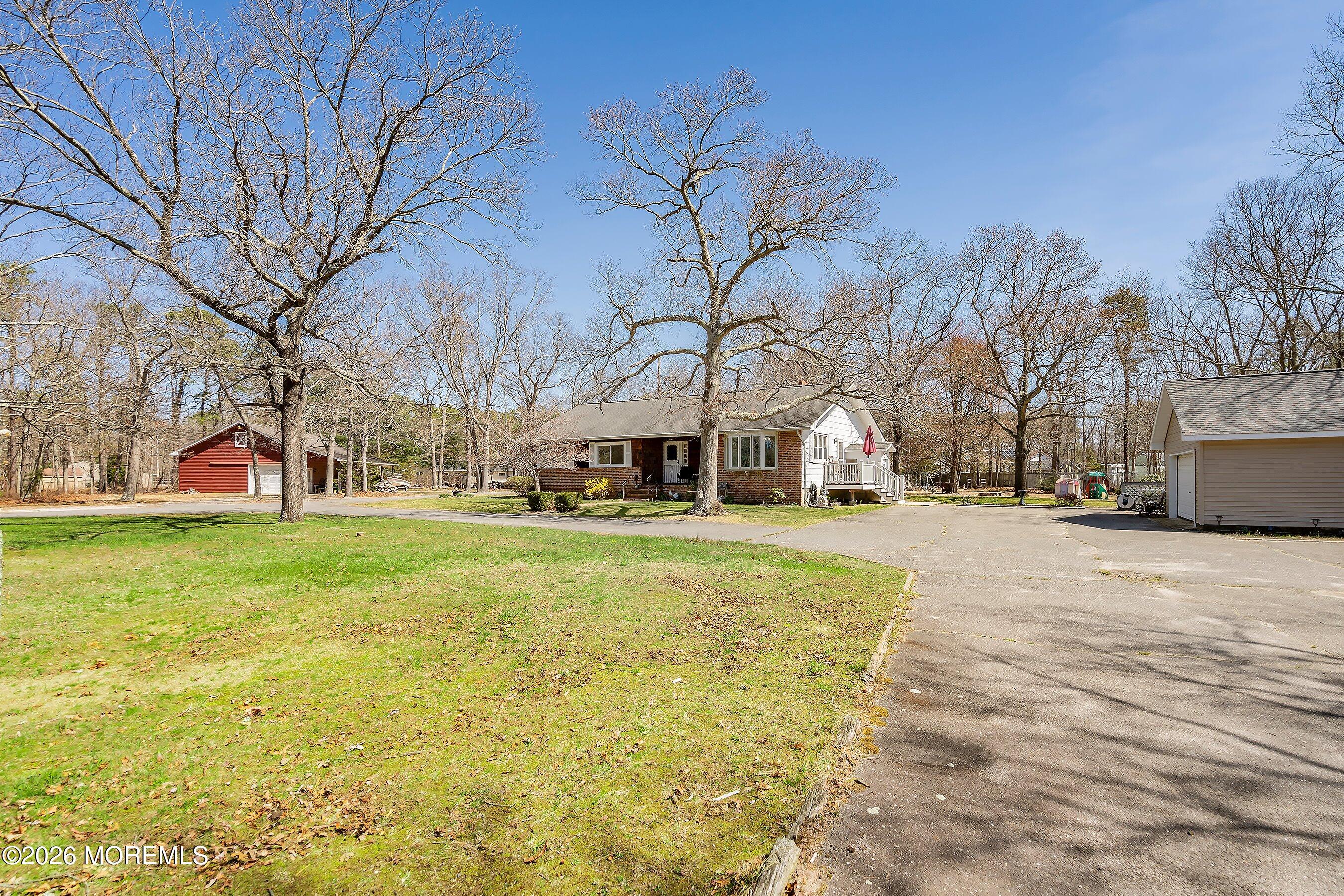 745 Oak Glen Road Howell, NJ 07731 - Photo 7 of 46 a view of a swimming pool with tree s
