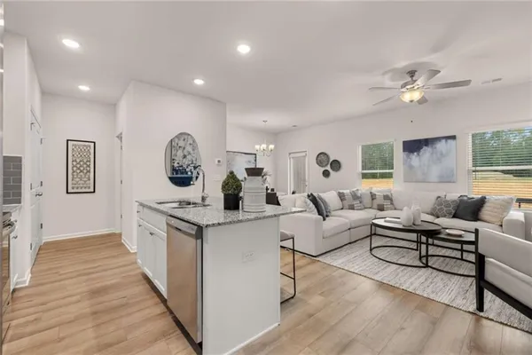 a living room with furniture and a wooden floor