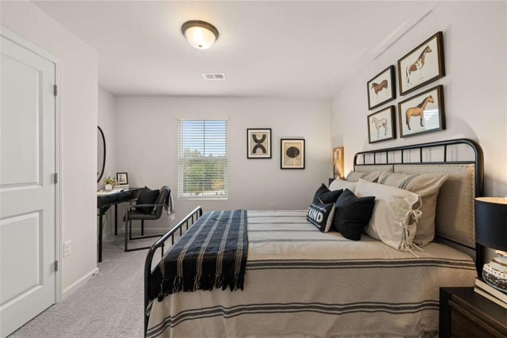 1034 Merritt Drive, Unit 18 Villa Rica, GA 30180 - Photo 13 of 37 a bedroom with a bed and wooden floor