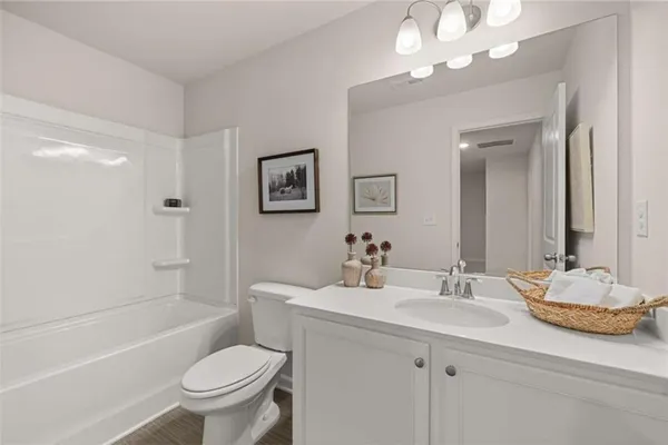 a en suite bathroom with a sink mirror and view