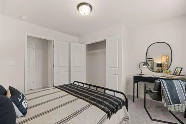 a bedroom with a bed and a dresser