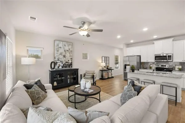 a living room with furniture kitchen view and a fireplace