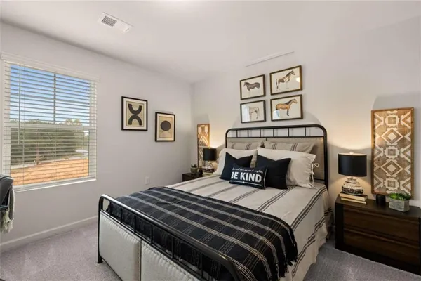 a bedroom with a bed and a window