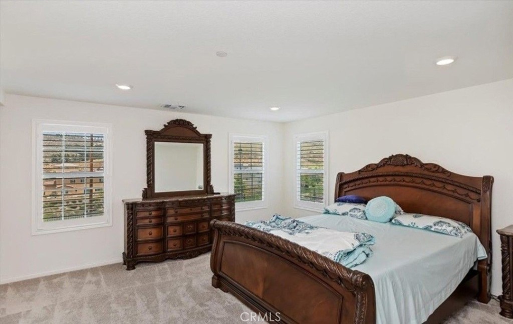 21288 Telegraph Road Riverside, CA 92507 - Photo 13 of 23 a spacious bedroom with a bed and a window
